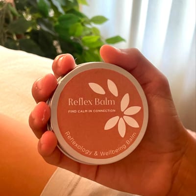Harriet holding Reflex Balm tin
